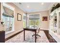 Bright home office with large windows, custom built-ins, and a comfortable workspace, perfect for productivity at 14041 Mccord Rd, Huntersville, NC 28078