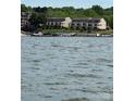 Scenic lake view showcasing waterfront homes with boat docks on a sunny day at 14608 Waterside Dr, Charlotte, NC 28278