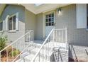Inviting entryway features a gray painted brick exterior and white-painted stairs and railing at 14821 Cumberland Dr, Charlotte, NC 28227