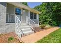 Charming front entryway with painted brick, leading to a welcoming front door at 14821 Cumberland Dr, Charlotte, NC 28227