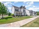Beautiful home featuring well-maintained landscaping, a welcoming front porch, and a sidewalk at 15103 Keyes Meadow Way, Huntersville, NC 28078