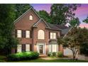 Charming brick two-story home with landscaped front yard taken at twilight at 17433 Glassfield Dr, Huntersville, NC 28078