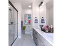 Bright bathroom features double vanity, sleek fixtures, glass enclosed shower, and tasteful decor at 2158 N Graham St # 14, Charlotte, NC 28206