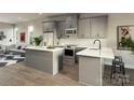 Eat-in kitchen featuring white countertops, gray cabinets, stainless appliances, and open layout at 2158 N Graham St # 14, Charlotte, NC 28206