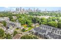 Stunning aerial view showcases a vibrant neighborhood with lush greenery and a picturesque city skyline at 223 S Bruns Ave, Charlotte, NC 28208