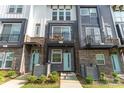Close-up of townhome exteriors featuring brick accents, individual balconies, and quaint front yards at 223 S Bruns Ave, Charlotte, NC 28208