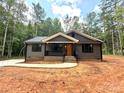 Inviting home with gray siding, covered porch, black railings and trim, and a walkway leading to the entrance at 2330 Neill Rd, Lancaster, SC 29720