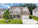 Charming two-story home with covered front porch, manicured lawn and attached two-car garage at 2577 Shoal Park Rd, Concord, NC 28027