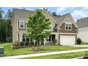 Charming two-story home with a well-manicured lawn and inviting front porch at 2577 Shoal Park Rd, Concord, NC 28027