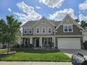 Two-story home with landscaped front yard, covered porch, and attached two-car garage at 2577 Shoal Park Rd, Concord, NC 28027