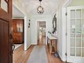 Welcoming entryway with hardwood floors, console table, and stylish light fixture at 327 Whitestone Rd, Charlotte, NC 28270