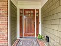 Elegant wood front door with sidelights and decorative hardware at 327 Whitestone Rd, Charlotte, NC 28270