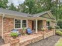 Inviting brick porch with seating, perfect for enjoying the outdoors at 327 Whitestone Rd, Charlotte, NC 28270
