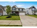 Beautiful two-story home with stone accents, lush lawn, and attached two car garage at 334 Kennerly Center Dr, Mooresville, NC 28115