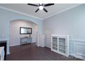 Bright living room featuring hardwood floors, arched doorways, and fresh paint at 334 Kennerly Center Dr, Mooresville, NC 28115