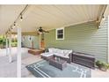 Covered back patio with comfortable seating, ceiling fan, and outdoor lighting, ideal for entertaining at 3980 English Oak Dr, Lincolnton, NC 28092