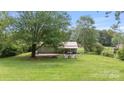 Charming home with a metal roof, a spacious yard, and a cozy outdoor seating area at 3980 English Oak Dr, Lincolnton, NC 28092