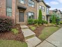 View of attractive brick townhome showing landscaped front yard and welcoming entry at 416 Linestowe Dr, Belmont, NC 28012