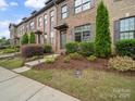 Attractive exterior view of brick townhome with well-manicured lawn and tidy landscaping at 416 Linestowe Dr, Belmont, NC 28012