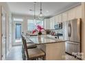 Modern kitchen boasts stainless steel appliances, an island with bar seating, and ample cabinet space for culinary enthusiasts at 416 Linestowe Dr, Belmont, NC 28012