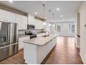 Modern kitchen with white cabinets, granite countertops, stainless steel appliances and wood flooring at 416 Moondance Dr # 121, Gastonia, NC 28054