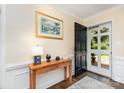 Inviting foyer with wood floors, light walls, hall table, and a front door view of the greenery outside at 441 Crestside Se Dr, Concord, NC 28025