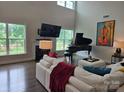 Bright living room with high ceilings, large windows, grand piano, and fireplace at 5000 Britannia Blvd, Waxhaw, NC 28173