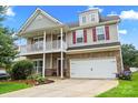 Inviting two-story home featuring a charming front porch, stone accents, and a well-manicured lawn at 5111 Elementary View Dr, Charlotte, NC 28269