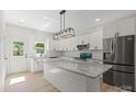 Modern kitchen featuring a large island with countertop seating, stainless steel appliances and white cabinetry at 5526 Brookwood Ln, Hickory, NC 28602