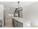 Kitchen island with beverage center next to fireplace; perfect for entertaining in a home at 5526 Brookwood Ln, Hickory, NC 28602