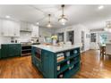 Spacious kitchen features an island with built-in microwave, white countertops, and hardwood floors at 5533 Murrayhill Rd, Charlotte, NC 28210