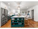 Stunning kitchen featuring a large center island, stainless steel appliances, and hardwood floors at 5533 Murrayhill Rd, Charlotte, NC 28210