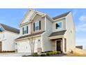 Well-maintained two-story home featuring a two-car garage and landscaped front yard at 5775 Soft Shell Dr # 310, Lancaster, SC 29720