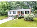Attractive two-story brick home with an attached garage and a manicured lawn at 5909 Ryder Ave, Charlotte, NC 28226