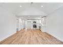 Open concept living space boasts modern flooring, vaulted ceiling, and white shaker cabinets at 707 W Davidson Ave, Gastonia, NC 28052