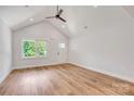 Bright living area with vaulted ceilings, modern flooring, and natural light from a large window at 707 W Davidson Ave, Gastonia, NC 28052