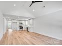Open concept living space boasts modern flooring, vaulted ceiling, and white shaker cabinets at 707 W Davidson Ave, Gastonia, NC 28052