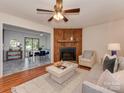 Inviting living room with a wood-burning fireplace, stylish furnishings, and an open view to the dining area at 713 Springfield Nw Dr, Concord, NC 28027