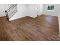 Empty living room with hardwood flooring, staircase, and natural light. Ready to be furnished! at 7134 Rollingridge Dr, Charlotte, NC 28211