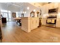 A gourmet kitchen featuring stainless appliances, a stylish island, and sleek white cabinets at 720 Governor Morrison St # 221, Charlotte, NC 28211