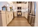 Bright kitchen featuring stainless steel appliances, white cabinetry, and ample counter space at 720 Governor Morrison St # 221, Charlotte, NC 28211