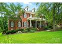 Charming brick residence featuring a welcoming front porch and well-manicured garden, radiating curb appeal at 748 Land Fall Dr, Rock Hill, SC 29732