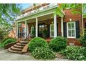 Inviting front porch with brick steps, columns, and decorative plants, creating a warm entrance at 748 Land Fall Dr, Rock Hill, SC 29732