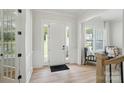 Bright entryway featuring a white door with sidelights and wood flooring at 7818 Russell Rd, Indian Trail, NC 28079