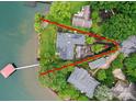 Aerial view of lakefront property with lush landscaping, private dock and ample parking space at 7945 Placid Ct, Denver, NC 28037