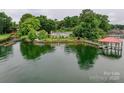 Picturesque lakefront home with lush greenery and private dock, perfect for relaxing at 7945 Placid Ct, Denver, NC 28037