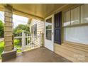 Covered front porch with white picket fence and view of the front yard at 807 3Rd St, Kings Mountain, NC 28086