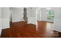 Spacious living room featuring hardwood floors, arched doorways, and ample natural light at 8115 Kelburn Ln, Charlotte, NC 28273
