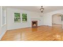 Bright living room with hardwood floors, fireplace, and white trim at 1106 S South St, Gastonia, NC 28052