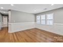 Well-lit bedroom with hardwood floors and ample natural light from large windows at 113 W 5Th Ave, Gastonia, NC 28052